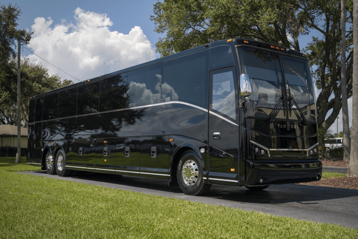 CX series transit bus large in black with greenery background